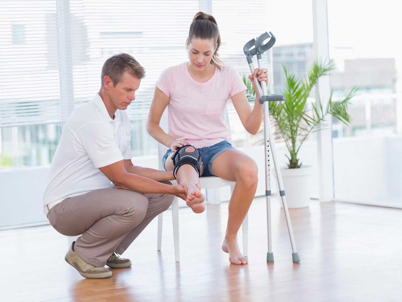 Doctor examining patient knee, WaveBreakiMediaMicro